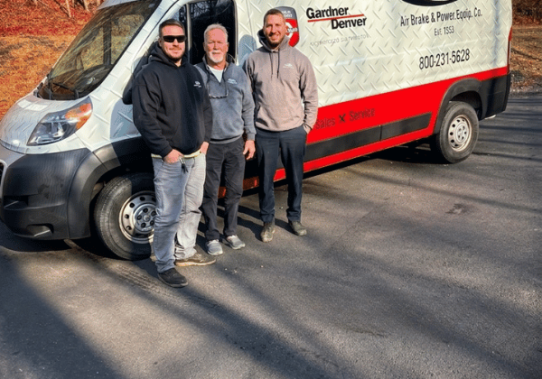 Matthew, Eddie, and Ed Jr. in front of an Air Brake & Power van