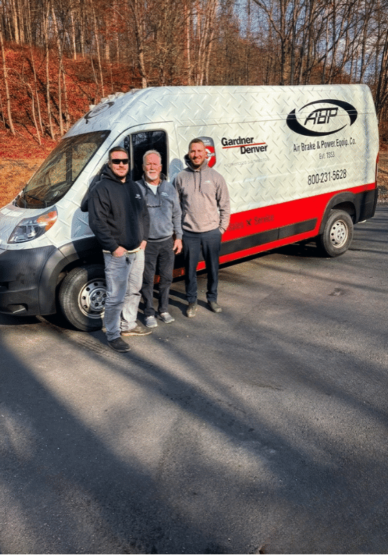 Matthew, Eddie, and Ed Jr. in front of an Air Brake & Power van