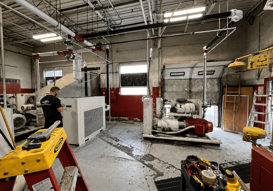 A man conducting an audit in a room full of machines