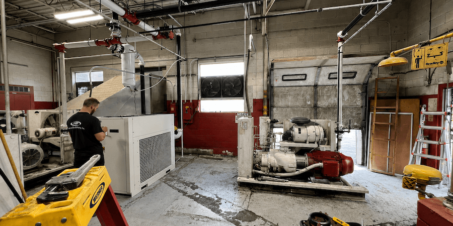 A man conducting an audit in a room full of machines