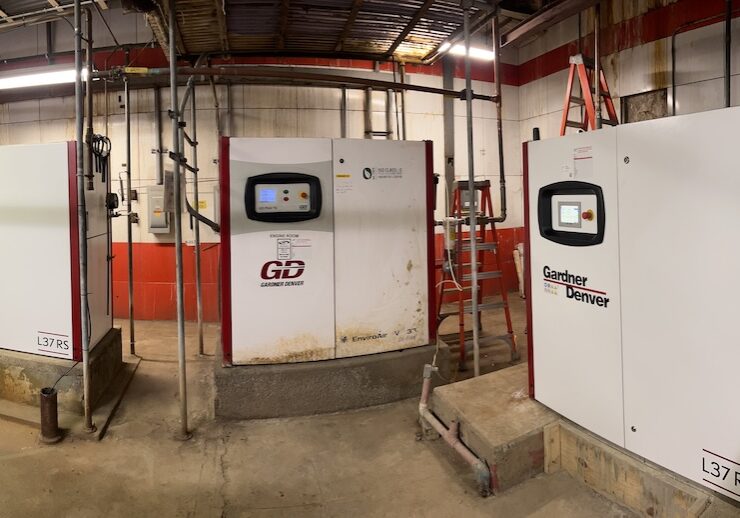 Three industrial air compressors